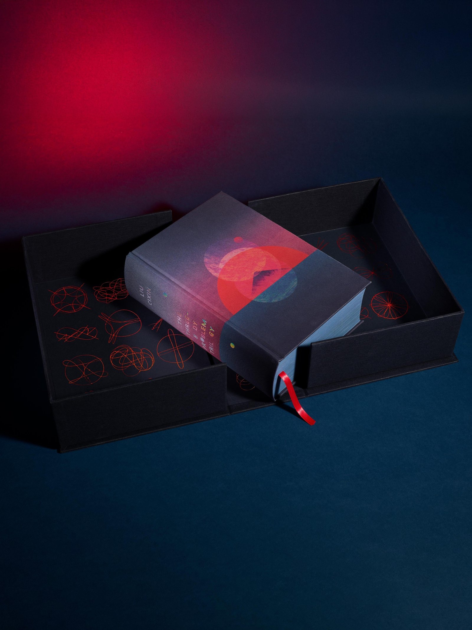 The Three-Body Problem Folio Society Limited Edition - the book resting in its open clamshell case with a red ribbon - fivestaredition.com
